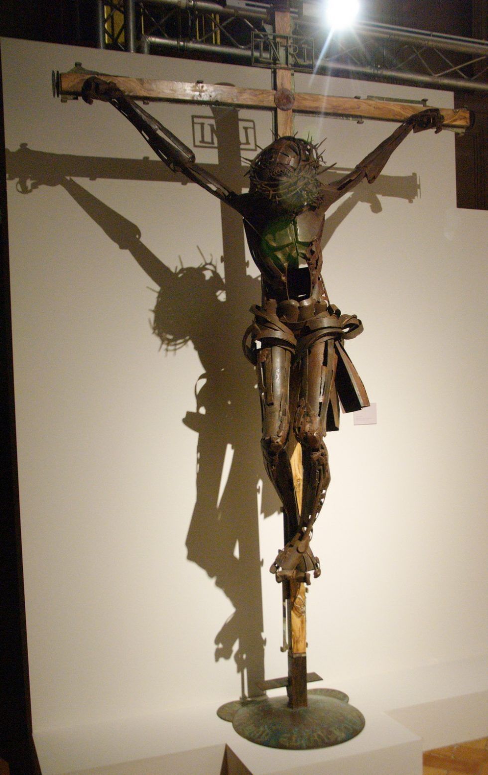 Escultura de crucificado de hierro en su color, acabado a la cera con unas dimensiones de 285 X 174 cm.